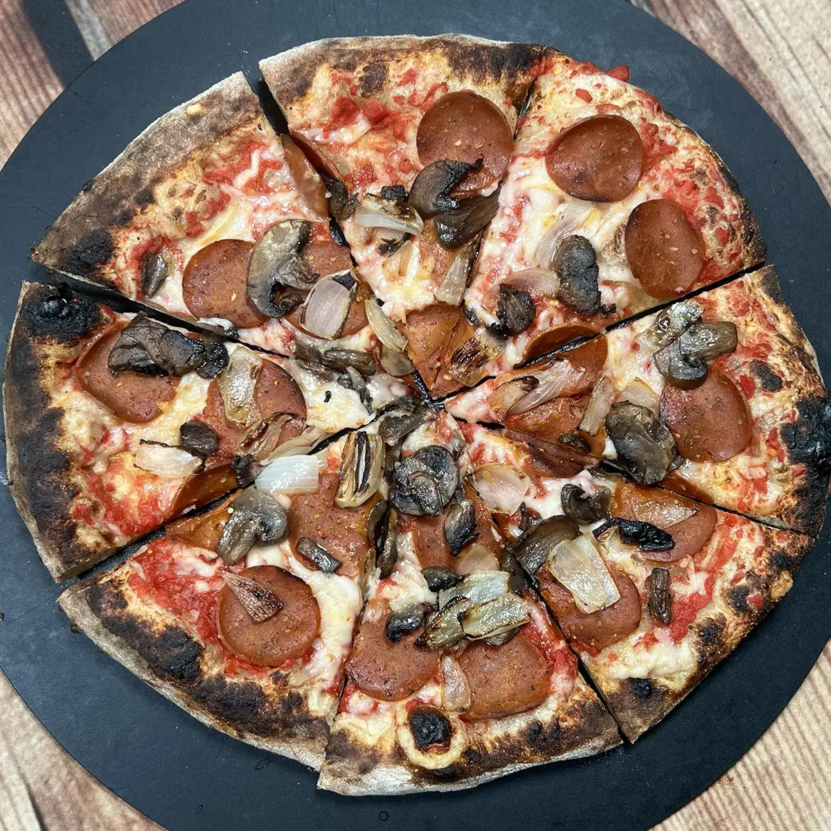 Vegan Farmhouse Pepperoni Pizza from Fire & Char - Richmond, VA. Plant-based pizza with Be-Hive vegan pepperoni, mushrooms, caramelized onions, and melted Be-Hive mozzarella. Delicious vegan pizza in Richmond and Henrico, VA.