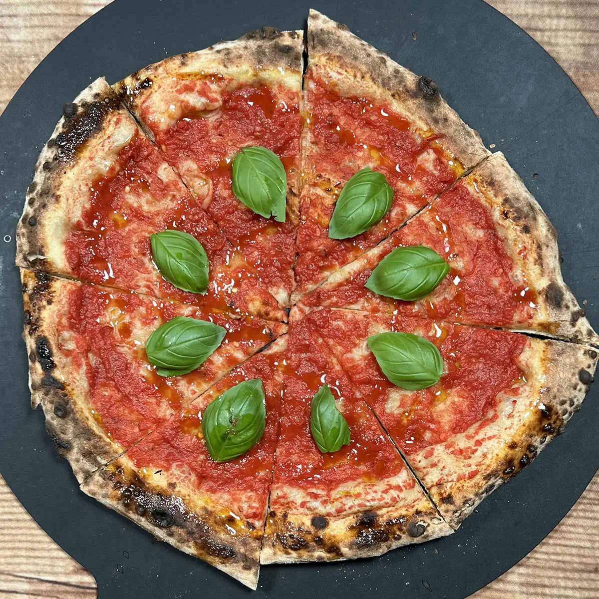 Vegan Red Pizza from Fire & Char – Classic Vegan Pizza in Richmond, VA with tomato sauce, extra virgin olive oil, and fresh basil.