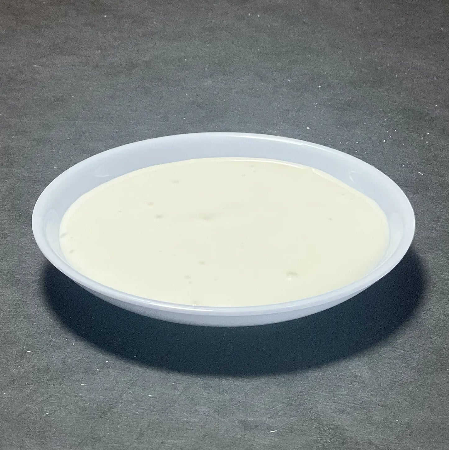 Side of Ricotta Cream from Fire & Char - A smooth, tangy blend of ricotta and sour cream, perfect for dipping, spreading, or topping your favorite pizza.