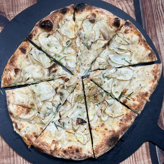 Vegan Spud Pizza from Fire & Char - Richmond, VA. Plant-based pizza with Be-Hive vegan mozzarella, rosemary potatoes, caramelized onions, lemon oil, fresh rosemary, and chives. Delicious vegan pizza in Richmond and Henrico, VA.